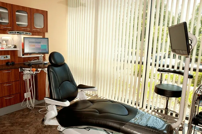 A treatment room with a chair-side monitor, from the practice's office tour of its former suite.