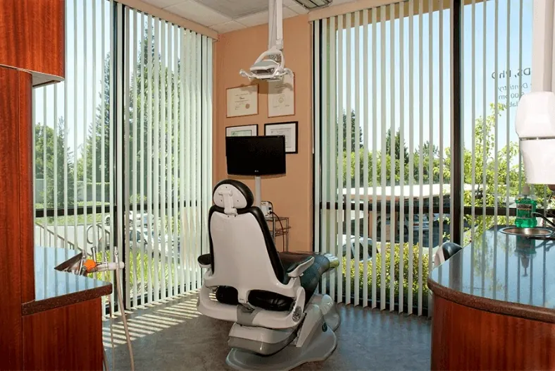 A corner treatment room looking out onto trees.