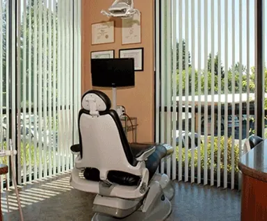 A treatment room with tall windows, from the practice's own photographs.