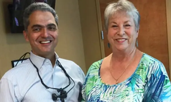 Dr. Okhovat with a smiling patient at Roseville Topsmiles.